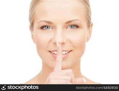 picture of happy woman with finger on lips