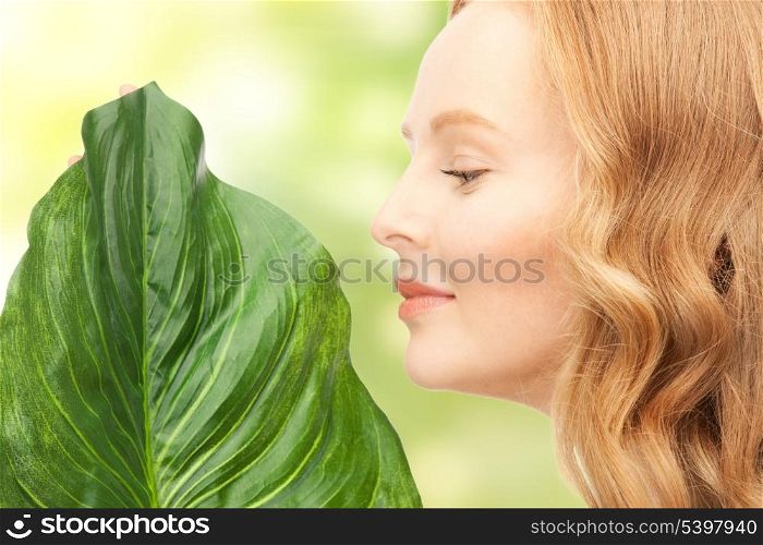 picture of happy woman with green leaf