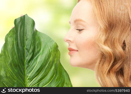 picture of happy woman with green leaf