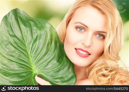 picture of happy woman with green leaf