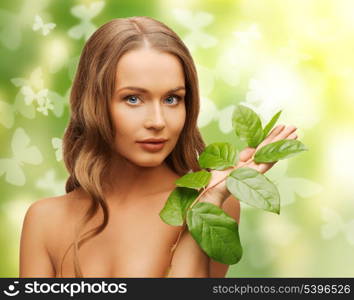 picture of happy woman with green leaf and butterflies