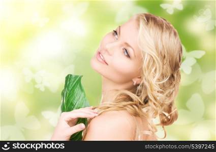 picture of happy woman with green leaf and butterflies