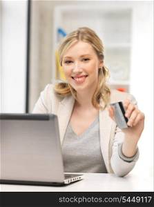 picture of happy woman with laptop computer and credit card.