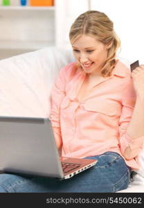 picture of happy woman with laptop computer and credit card..