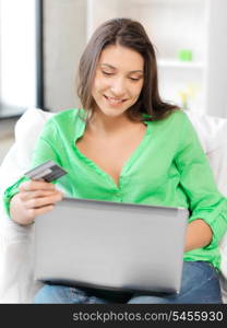 picture of happy woman with laptop computer and credit card