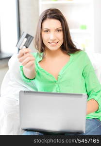 picture of happy woman with laptop computer and credit card