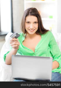 picture of happy woman with laptop computer and credit card