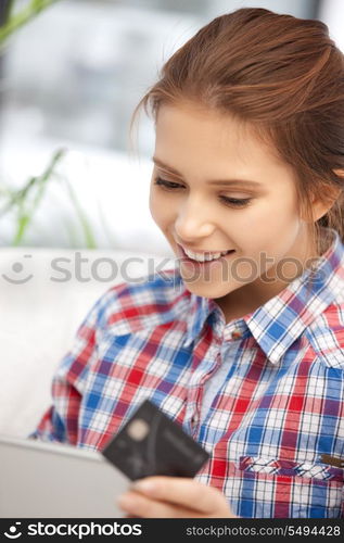 picture of happy woman with laptop computer and credit card