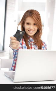 picture of happy woman with laptop computer and credit card