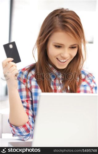 picture of happy woman with laptop computer and credit card
