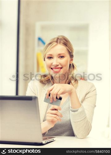 picture of happy woman with laptop computer and credit card.. happy woman with laptop computer and credit card