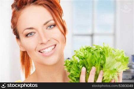 picture of happy woman with lettuce in the kitchen