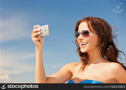 picture of happy woman with phone on the beach.