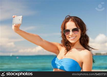 picture of happy woman with phone on the beach.