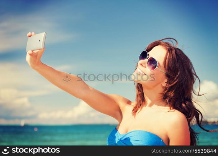 picture of happy woman with phone on the beach