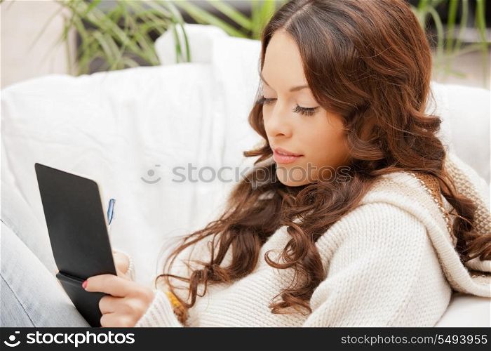 picture of happy woman with small notepad