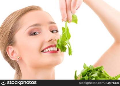 picture of happy woman with spinach over white