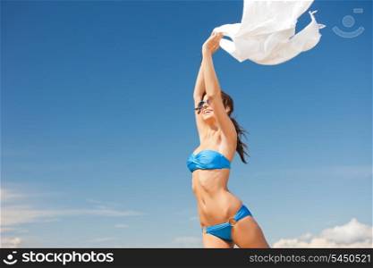 picture of happy woman with white sarong on the beach.