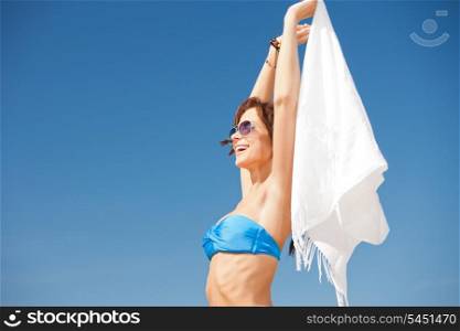 picture of happy woman with white sarong on the beach.