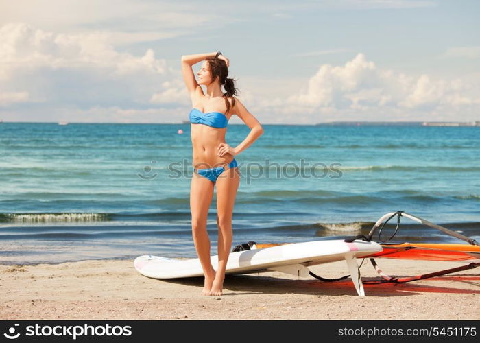 picture of happy woman with wind surf on the beach.