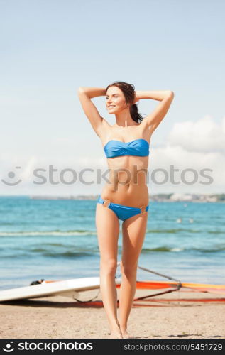 picture of happy woman with wind surf on the beach.