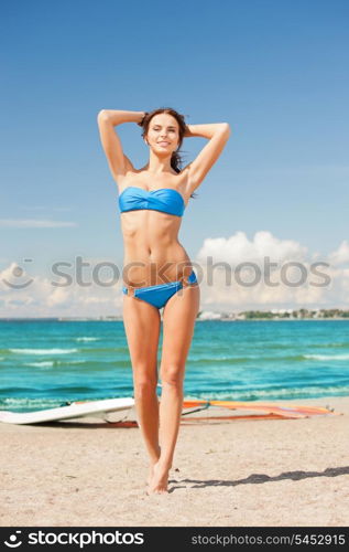 picture of happy woman with wind surf on the beach.