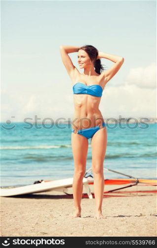 picture of happy woman with wind surf on the beach