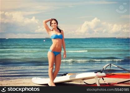 picture of happy woman with wind surf on the beach