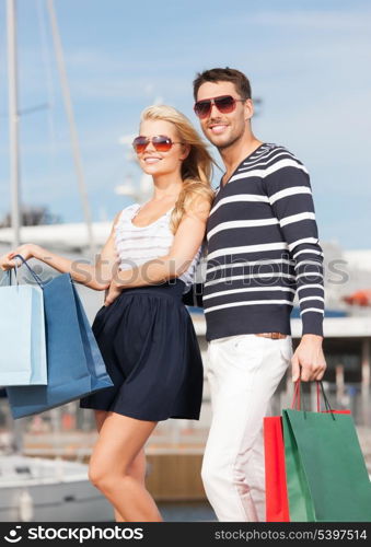 picture of happy young couple with shopping bags