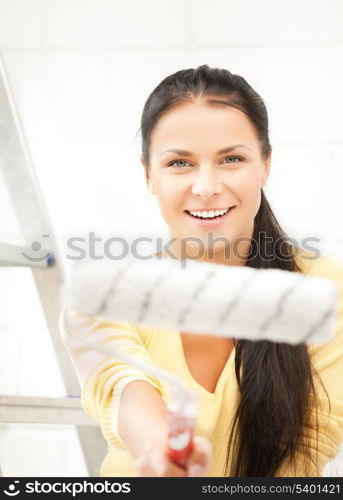 picture of happy young woman with paintroller