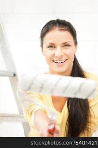 picture of happy young woman with paintroller