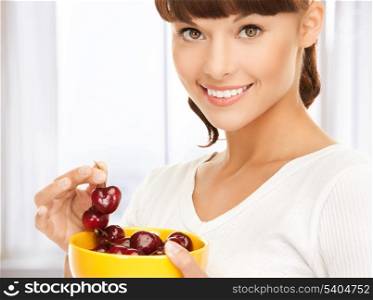 picture of healthy woman holding bowl with cherries