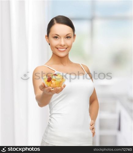 picture of healthy woman holding bowl with fruit salad
