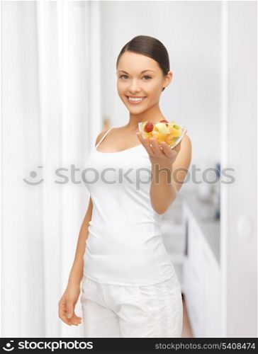 picture of healthy woman holding bowl with fruit salad