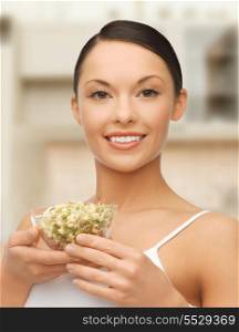 picture of healthy woman holding bowl with sprout