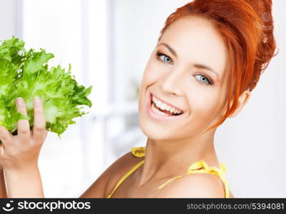 picture of healthy woman holding bunch of lettuce