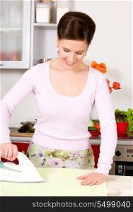 picture of ironing woman in the kitchen
