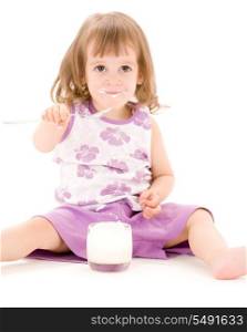 picture of little girl eating yoghurt over white