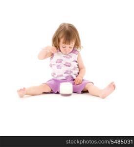 picture of little girl eating yogurt over white
