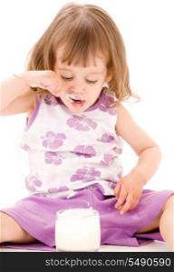 picture of little girl eating yogurt over white