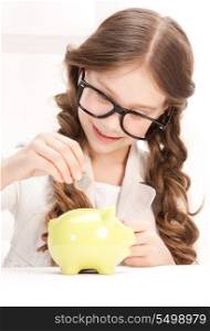 picture of little girl with piggy bank and coin