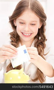 picture of little girl with piggy bank and money