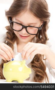 picture of little girl with piggy bank and money