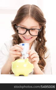 picture of little girl with piggy bank and money