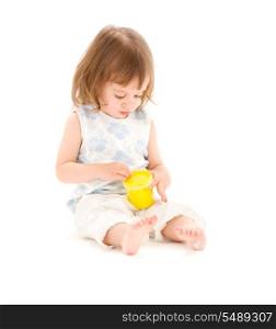 picture of little girl with yellow modelling foam over white