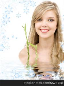 picture of lovely blue-eyed blonde with bamboo in water