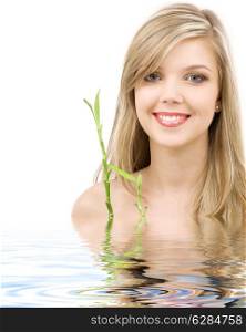 picture of lovely blue-eyed blonde with bamboo in water