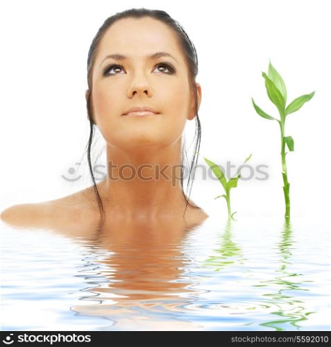 picture of lovely brunette with bamboo in water