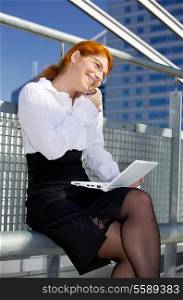 picture of lovely businesswoman with cell phone and laptop