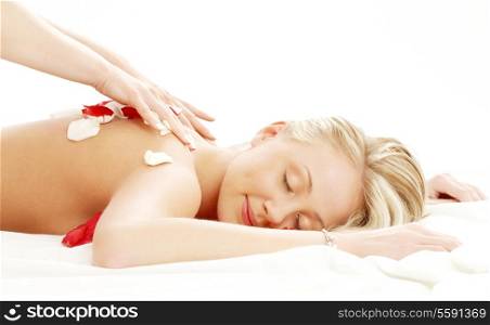 picture of lovely lady with flower petals in massage salon